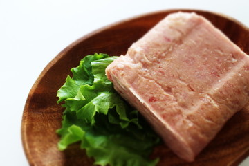 Canned food, luncheon meat on wooden plate