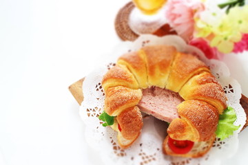 Luncheon meat in croissant sandwich
