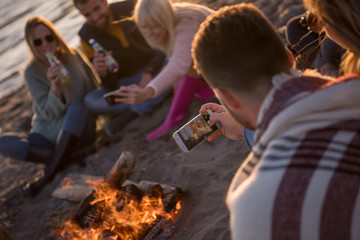 Friends having fun at beach on autumn day