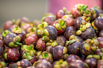 Background, mangosteen, a sweet and sour fruit. Seasonal out, colorful outside, beautiful inside, white