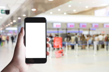 Woman passenger hand holding empty screen of smart phone and check-in counter airport terminal...