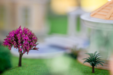 Background, house models (small trees, cars, grass, parking space) are shown to customers before the introduction of the service.