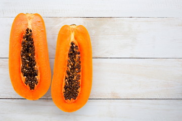 Papaya fruit on white wooden desk with copy space,Top view.