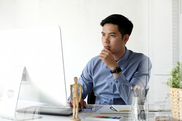 Young asian businessman working on a computer in an office