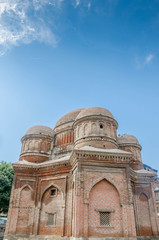 Fototapeta na wymiar Graves surround the Tomb of Budshah, a popular tourist attraction in Srinagar, Kashmir, India.