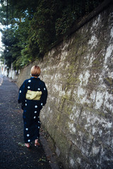 Back of a woman standing wearing a yukata