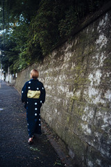 A woman wearing a yukata is walking along a path