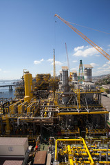 Fototapeta na wymiar Equipment on a large petroleum ship in the bay of Rio de Janeiro with the bay bridge in the background