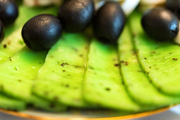 Cheese plate with fresh olives close up