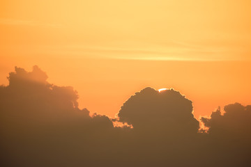 Orange light, sun and big clouds