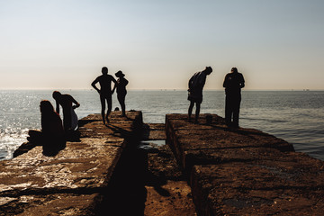 People rest on the pier. Silhouette photo.