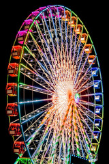 Ferris Wheel Spinning Round Illuminated in Night Sky