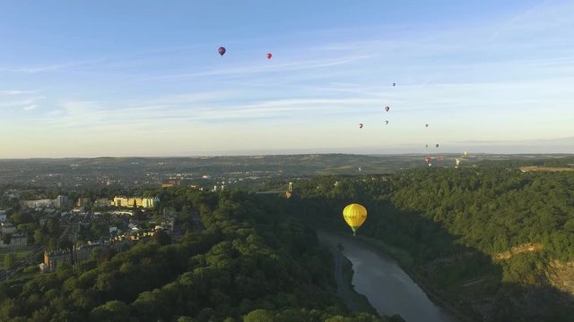 Aerial Drone Shot of Hot Air Balloons flying over Forest & River Landscape, Bristol Balloon Fiesta 2018