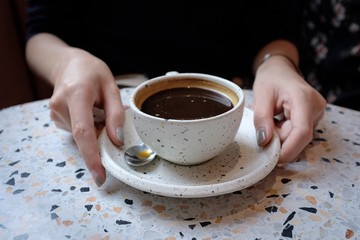 Woman holding a cup of coffee