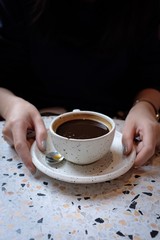 Woman holding a cup of coffee