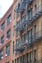 ancient brick building with fire ladder on the wall