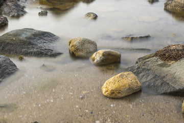 The beach with stones. Big stones on the beach. Morning inflow of water. Bulgaria, Burgas, Nessebar, Olympic Hope beach
