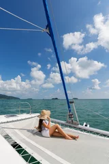 Fotobehang Lifestyle series: Asian woman relaxing on catamaran yacht © bhakpong