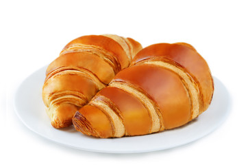 Croissants on the white plate isolated