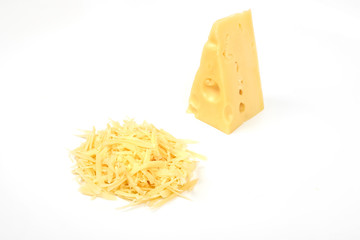 piece of cheese and heap of grated cheese, isolated on white background.