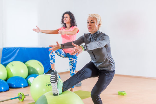 Active Middle-aged Woman Working Out With Stability Ball Taking Part In Group Fitness Class