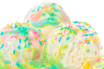 Fototapeta na wymiar white melting scoop of milk ice cream with rainbow glaze and sprinkles isolated on white background, close up