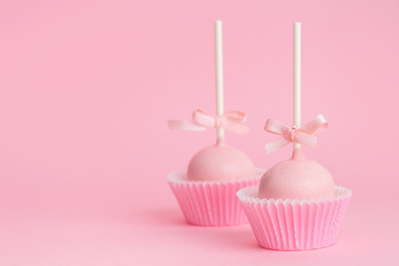 couple festive icing cake pops over pink background, concept of Valentines day