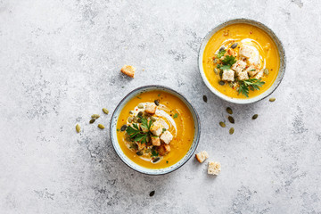 Pumpkin puree soup with cream, croutons and pumpkin seeds.