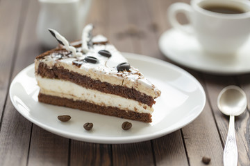 Souffle cake with chocolate sauce and coffee, on a wooden table.