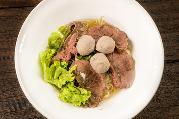 Chinese noodles with braised beef and meatball delicious Chinese style Asian favorite Thai street food.
