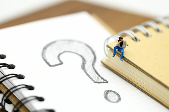Miniature people : Businessman with THE QUESTION MARK using for concept Punctuation Day