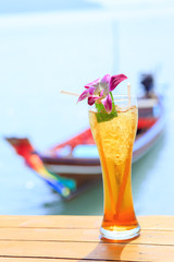 glass of ice tea on tropical background