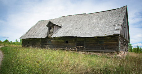 An old abandoned wooden shed with a roof of slate in the village.