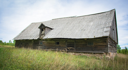 An old abandoned wooden shed with a roof of slate in the village.