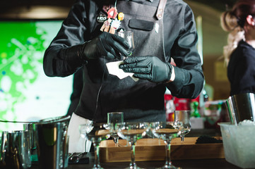championship among coffee houses, members of teams show barista's skill, prepare drinks, teamwork. pours drink into glasses