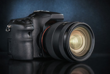 Studio shot of a digital SLR camera with a lens.