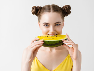 Woman with watermelon eating tasty fruit funny girl yellow dress and fruit