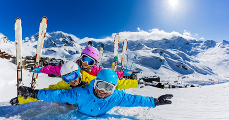 Happy family enjoying winter vacations in mountains, Val Thorens, 3 Valleys, France. Playing with snow and sun in high mountains. Winter holidays.