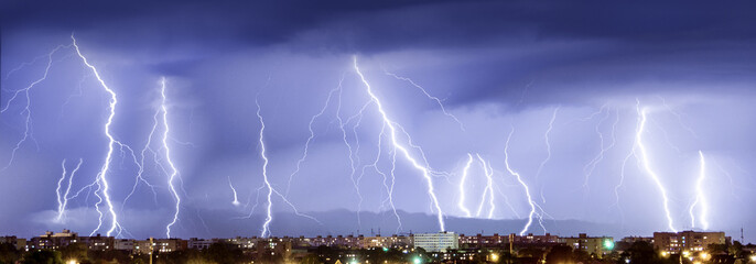 Night. Thunderstorm, flash of lightning above the city.
