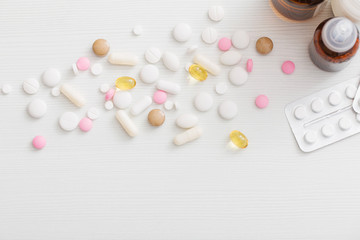 pills on  white wooden table