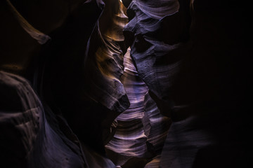 sunlight casts down from the opening inside the cave Slot Canyon