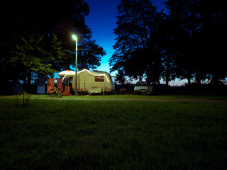 camper van at night next to a light post