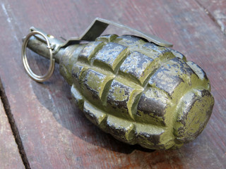 Soviet and russian hand grenade F-1 on wooden table. Famous russian weapon