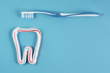 Toothbrush and toothpaste on blue