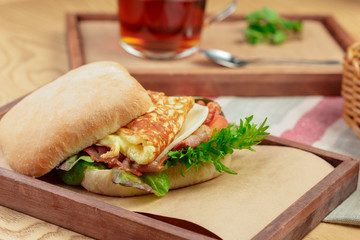 Delicious burger with omelette breakfast dish close up