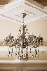 Photo of vintage crystal chandelier in the restaurant.