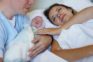 Young parents together with a newborn daughter.