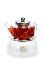 Glass teapot with fruit slices isolated on white background
