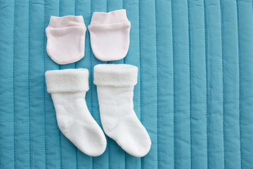 Baby clothes for newborn on blue background.