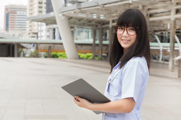 The woman Asian doctor  White Shirt suit with stethoscope working outdoor Hospital.